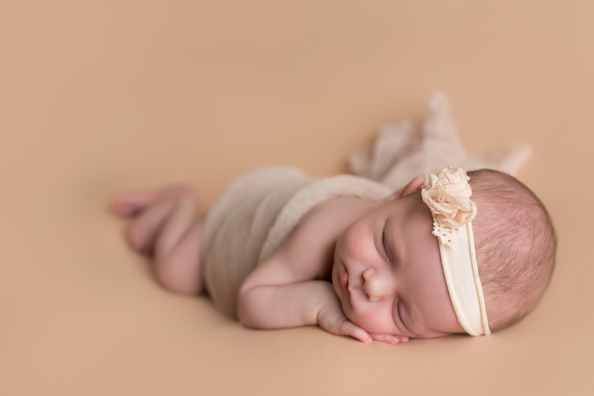 Newborn girl laying on pink taken by DMV newborn photographer Sarah Botta Photography in Woodbridge, VA studio