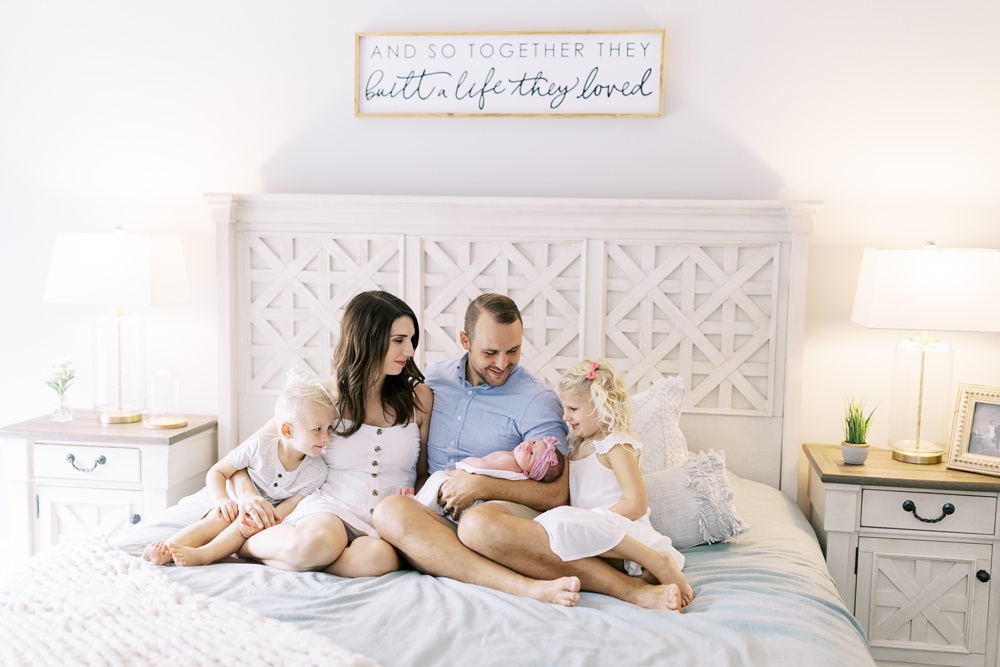 Winchester Virginia family at newborn session sitting on bed